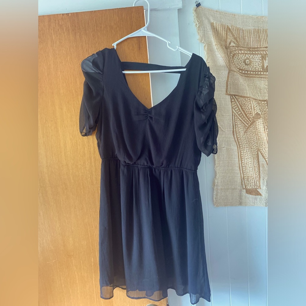 Little black dress with gauzy sleeves.